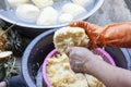 A woman`s hand held a fork to grate the pineapple into small pieces. Royalty Free Stock Photo