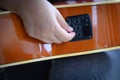 Woman`s hand holding of an acoustic guitar equalizer Royalty Free Stock Photo