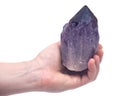 Woman`s hand holding Ametrine lightbrary point from Bolivia