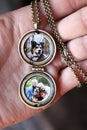 Woman`s Hand Holding Antique Locket with Photos of Children and Pet Dog Inside Royalty Free Stock Photo