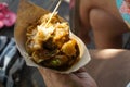 Woman\'s hand holding Balinese food.