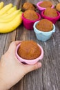 Woman's hand holding banana cake in colorful baking pan. Royalty Free Stock Photo