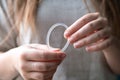 Woman`s hand holding a birth control ring, vaginal ring for contraceptive