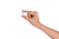 Woman's hand holding black pill Royalty Free Stock Photo