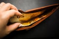 Woman`s hand holding a black wallet with euro money Royalty Free Stock Photo