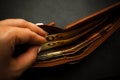 Woman`s hand holding a black wallet with euro money Royalty Free Stock Photo