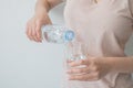 Woman`s hand holding a bottle of water Pouring water into a glass Royalty Free Stock Photo