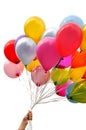 Woman`s hand holding bunch of multicolored balloons