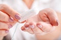 Woman`s hand holding a clean cotton tampon