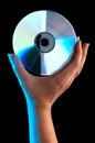 A woman's hand holding a compact disc Royalty Free Stock Photo