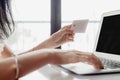 Woman`s hand holding a credit card and using computer for online shopping and payment Royalty Free Stock Photo