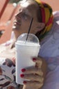 Woman`s hand holding a cup of Greek frappe with drinking straw Royalty Free Stock Photo