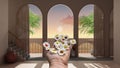 Woman`s hand holding daisies, spring and flowers idea, over dreamy terrace, over sea sunset or sunrise with moon and cloudy sky,