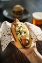 Woman`s hand holding a delicious vegan carrot dog Royalty Free Stock Photo