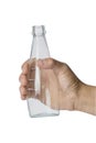 Woman`s hand holding empty glass bottle transparent on white background Royalty Free Stock Photo