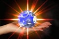 Woman's hand holding an exploding earth Royalty Free Stock Photo