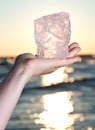 Woman`s hand holding gem grade rough Rose Quartz chunk from Madagascar Royalty Free Stock Photo