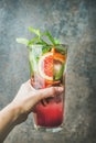 Woman`s hand holding glass of blood orange citrus lemonade Royalty Free Stock Photo