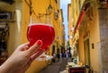 Woman s hand with a glass of raspberry Lambic ale at a restaurant in Nice France