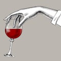 Woman`s hand holding a glass with red wine Royalty Free Stock Photo