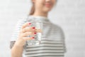 Woman`s of hand holding a glass of water on white background Royalty Free Stock Photo