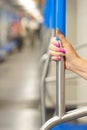 woman& x27;s hand holding the handrail in a subway car Royalty Free Stock Photo