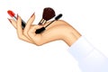 Woman`s hand holding makeup items