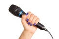 Woman's hand holding a microphone Royalty Free Stock Photo