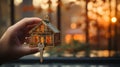 Woman\'s hand holding a model of a wooden house with a key. Royalty Free Stock Photo