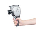 Woman`s hand holding an old 8 mm movie camera isolated on white background. File contains a path to isolation Royalty Free Stock Photo