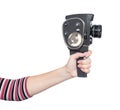 Woman's hand holding an old 8 mm movie camera, isolated on white background. Royalty Free Stock Photo