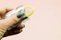 Woman`s hand holding opened condom in package Royalty Free Stock Photo