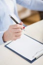 Woman's hand holding a pen