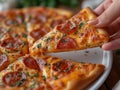 Woman\'s hand holding a piece of pepperoni pizza, close-up Royalty Free Stock Photo