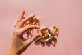 Woman`s hand holding a pill or dietic supplement capsule