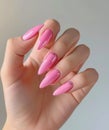 woman& x27;s hand holding pink nails