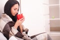 Woman`s hand holding a red cup of coffee. With a beautiful winte Royalty Free Stock Photo