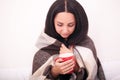 Woman`s hand holding a red cup of coffee. With a beautiful winte Royalty Free Stock Photo