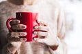 Woman`s hand holding a red cup of coffee. With a beautiful winter manicure. Drink, fashion, morning Royalty Free Stock Photo