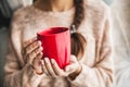 Woman`s hand holding a red cup of coffee. With a beautiful winter manicure. Drink, fashion, morning Royalty Free Stock Photo