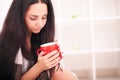 Woman`s hand holding a red cup of coffee. With a beautiful winte Royalty Free Stock Photo