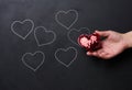 Woman's hand holding a red heart, donation and volunteering concept