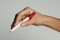 A woman`s hand with red pen. Royalty Free Stock Photo