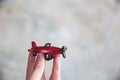 Hand holding red toy plane Royalty Free Stock Photo