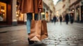 Woman`s hand holding shopping bags while walking on the street Royalty Free Stock Photo