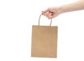 Woman`s hand holding shopping paper bag. Isolated on white Royalty Free Stock Photo