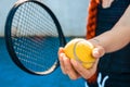Woman's hand holding a tennis ball and a racket Royalty Free Stock Photo