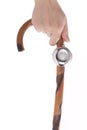 Woman's hand holding walking stick with bell