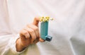 A woman`s hand holds an asthma inhaler. Royalty Free Stock Photo