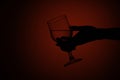Woman`s hand holds a glass. Isolated on a red background Royalty Free Stock Photo